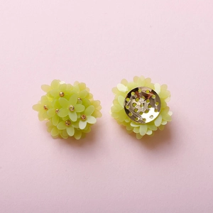 Detailed view of handmade lime green floral cluster earrings with golden bead accents