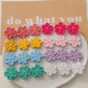 Detail view of colorful 3D resin cherry blossom flower charms for DIY crafts and jewelry