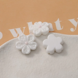 Macro detail of white cherry blossom resin petals with pink center for DIY crafts