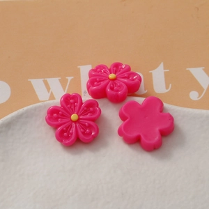 Macro detail of peach pink resin cherry blossom petals for DIY craft accessories