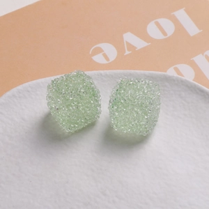 Détail macro de perles cubes de 16mm en résine vert clair avec texture sucrée givrée