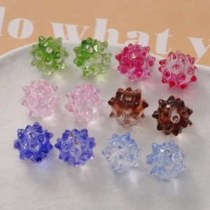 Macro detail of translucent sea urchin glass beads in vibrant colors for DIY jewelry