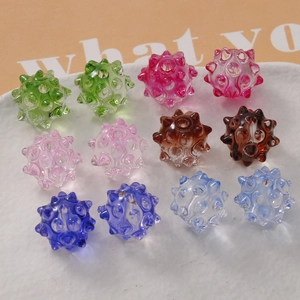 Macro detail of colorful urchin shaped glass beads with holes for DIY jewelry making