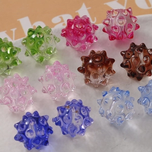 Macro shot of colorful translucent sea urchin spiked beads for DIY jewelry making