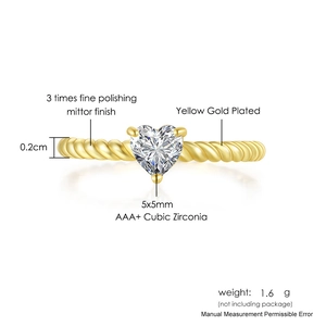 Macro detail of gold plated heart-shaped cubic zirconia ring with twisted rope band