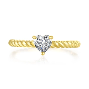 Close-up of heart-shaped zircon ring with twisted gold band and three-prong setting