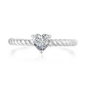 Detail of silver twisted band ring featuring a heart-shaped cubic zirconia in 3-prong setting