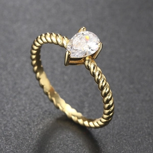 Detail of a pear-cut zircon set in a gold twisted rope band with four-prong mounting