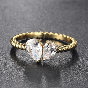 Detail view of the twisted gold band and twin pear-cut stones on this Toi et Moi ring