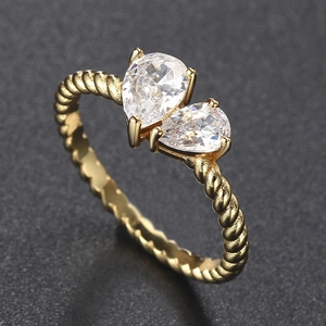 Detail of Toi et Moi gold ring with twin pear-cut cubic zirconia and twisted band texture