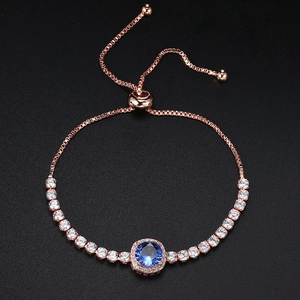 Detail of rose gold bolo bracelet featuring a blue halo crystal and adjustable box chain