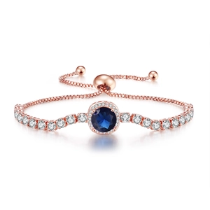 Detail of rose gold adjustable bracelet featuring blue gemstone and cubic zirconia accents