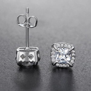 Macro shot of silver hip-hop stud earrings with halo cubic zirconia and side hollow details