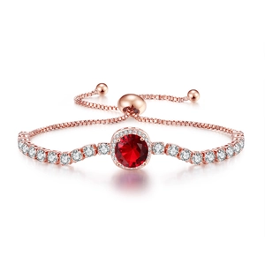 Detail of rose gold box chain bracelet with halo-set red stone and slide clasp