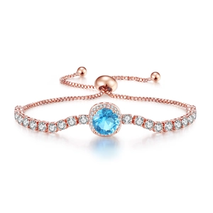 Detail of rose gold bolo bracelet with blue stone halo and adjustable box chain