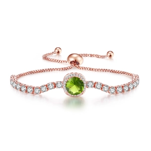 Detail of rose gold slide bracelet featuring a green zircon centerpiece and box chain
