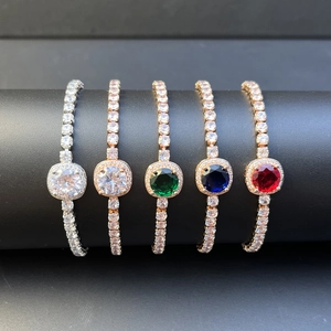 Adjustable tennis bracelet with colored zircon stones and halo centerpiece on display