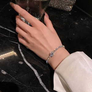 Elegant silver zircon bracelet for women with adjustable chain on dark background