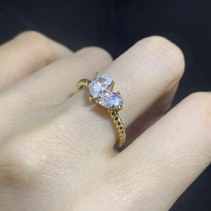 Classic gold twisted rope ring featuring double pear-shaped cubic zirconia stones