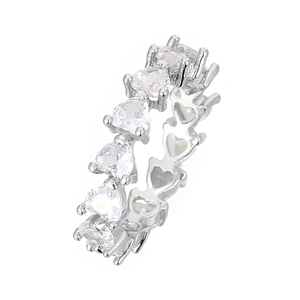 Macro detail of silver eternity ring featuring heart-cut cubic zirconia stones all around
