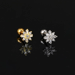 Western style gold and silver snowflake stud earrings with sparkling cubic zirconia stones