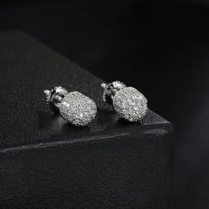 Macro shot of silver hip-hop earrings with full pave cubic zirconia and screw back