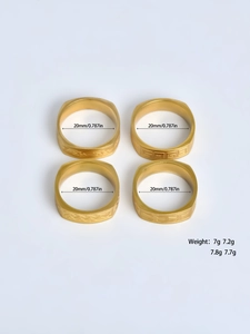 Detailed view of four gold stainless steel rings with Celtic and geometric patterns