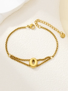 Detail van de vergulde roestvrijstalen schakelarmband met een letter O hanger