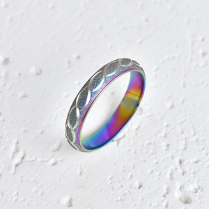 Twisted stainless steel ring with silver textured band and colorful iridescent interior