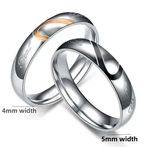 Detail of stainless steel couple rings with Real Love engraving and enamel heart