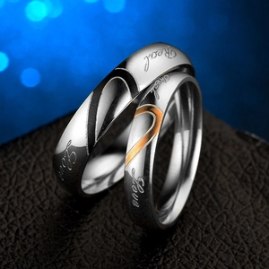 Polished stainless steel couple rings with heart pattern and Real Love engraving