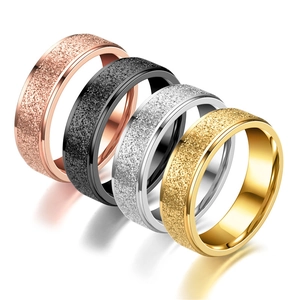 Detail of matte and polished finish stackable stainless steel rings in four metal colors