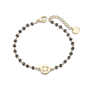 Detailed close-up of clover beaded bracelet featuring a smiley star charm and lobster clasp