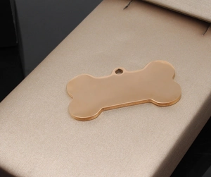Polished bone-shaped rose gold pet ID tag displayed on a premium silk gift box
