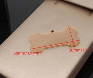 Macro shot of bone shaped stainless steel pet ID tag with 50mm length dimension markers