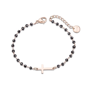 Detail of rose gold beaded bracelet with black faceted beads and engraved steel tag