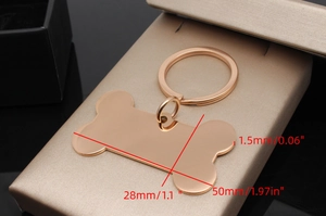 Detailed view of bone-shaped stainless steel dog tag with 50x28mm dimensions and key ring