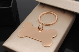 Macro shot of rose gold bone-shaped metal pet tag on premium champagne jewelry gift box