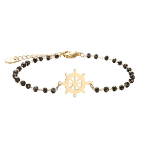 Detailed macro view of black faceted bead bracelet with golden ship wheel charm