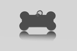 Macro shot of bone-shaped stainless steel pet ID tag in black with reflective finish