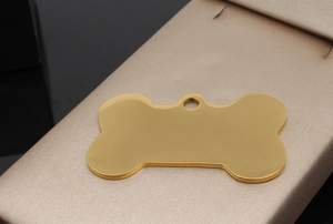 Polished gold bone-shaped pet ID tag on champagne satin lining for custom engraving