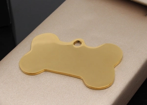 Polished gold bone-shaped stainless steel pet ID tag on a textured display stand
