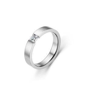 Detail of brushed silver titanium steel ring with an inset square clear zircon stone
