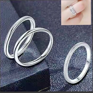 Close-up of three-piece silver stackable rings set with polished and textured finishes