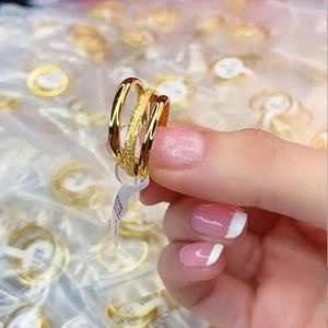 Close-up of three-piece titanium steel rings set featuring polished and frosted gold bands