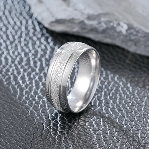 Macro shot of silver titanium ring featuring frosted center and polished beveled edges