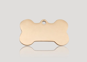 Polished bone-shaped rose gold pet ID tag with hole on a sleek reflective surface