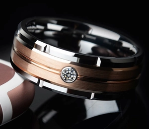 Macro shot of two-tone titanium ring with brushed rose gold finish and a single diamond