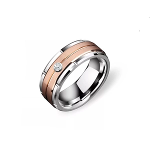 Detail of two-tone titanium ring featuring brushed rose gold center and inset cubic zirconia