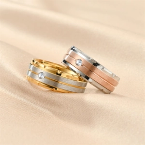 Macro detail of brushed titanium steel rings with inlaid zircon and gear edge design